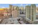A sprawling cityscape with modern high-rise buildings, parking structures, and busy roads against a blue sky at 145 E Harmon Ave # 2603, Las Vegas, NV 89109