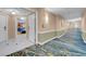Hallway with view into a unit through an open door and elegant carpets at 145 E Harmon Ave # 2603, Las Vegas, NV 89109