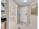 Bright hallway features stylish tile, elegant artwork, and entry to a luxurious bathroom at 145 E Harmon Ave # 2603, Las Vegas, NV 89109