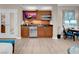 Suite kitchenette features wood cabinetry, microwave, mini-fridge, granite counters, and TV at 145 E Harmon Ave # 2603, Las Vegas, NV 89109