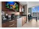 Close up of a condo kitchenette with black countertop, and a mini fridge, offering convenience and style at 145 E Harmon Ave # 2603, Las Vegas, NV 89109