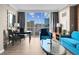 Bright living room featuring stylish furniture, decor, and a large window with a stunning city view at 145 E Harmon Ave # 2603, Las Vegas, NV 89109