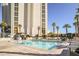 Rooftop pool area with lounge chairs and palm trees in front of the hotel building at 145 E Harmon Ave # 2603, Las Vegas, NV 89109