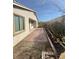 Backyard featuring brick pavers, mature landscaping, and access to the house at 1617 Meadow Bluffs Ave, Henderson, NV 89014