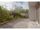 Landscaped backyard featuring a brick patio, mature foliage, and easy access to the house at 1617 Meadow Bluffs Ave, Henderson, NV 89014