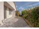 Private backyard with a brick patio, mature landscaping, and charming pergola at 1617 Meadow Bluffs Ave, Henderson, NV 89014