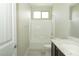 Bathroom with a shower-tub combo, marble countertop, and a window at 1617 Meadow Bluffs Ave, Henderson, NV 89014