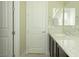 Bathroom featuring dual sinks, marble countertops, modern fixtures, and white paneled doors at 1617 Meadow Bluffs Ave, Henderson, NV 89014