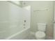 Bright bathroom featuring a tiled tub/shower combo, tiled flooring, and modern fixtures at 1617 Meadow Bluffs Ave, Henderson, NV 89014
