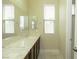 Elegant bathroom featuring dual sinks, marble countertops, and modern fixtures at 1617 Meadow Bluffs Ave, Henderson, NV 89014