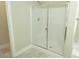Bathroom featuring a glass-enclosed shower with white tiling and a marble-look floor at 1617 Meadow Bluffs Ave, Henderson, NV 89014