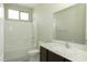 Bathroom featuring modern vanity with marble counter and a white tiled shower-tub combo at 1617 Meadow Bluffs Ave, Henderson, NV 89014
