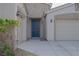 Inviting home featuring a blue front door, stone accents, and a two-car garage at 1617 Meadow Bluffs Ave, Henderson, NV 89014