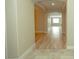 Hallway with wood floors and arched doorways leading to a sunlit room with a large window at 1617 Meadow Bluffs Ave, Henderson, NV 89014