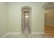 Hallway showcasing an arched doorway leading to a well-lit bathroom with modern fixtures at 1617 Meadow Bluffs Ave, Henderson, NV 89014