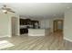 Bright, open kitchen with stainless steel appliances, granite countertops, dark cabinets, and wood flooring at 1617 Meadow Bluffs Ave, Henderson, NV 89014