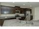 Modern kitchen with stainless steel appliances and dark wood cabinetry at 1617 Meadow Bluffs Ave, Henderson, NV 89014