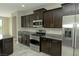 Well-equipped kitchen with stainless steel appliances and dark cabinets at 1617 Meadow Bluffs Ave, Henderson, NV 89014