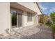 Charming patio with brick pavers, mature landscaping, and sliding glass door access to the home at 1617 Meadow Bluffs Ave, Henderson, NV 89014