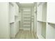 Spacious walk-in closet with custom shelving and drawers, offering generous storage solutions at 1617 Meadow Bluffs Ave, Henderson, NV 89014