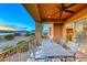 Outdoor dining area on a balcony with wrought iron furniture and a view of the lake and mountains at 20 Via Mantova # 106, Henderson, NV 89011