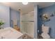 Bathroom featuring a shower with sliding glass doors and blue walls at 205 E Harmon Ave # 121, Las Vegas, NV 89169