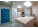 Bright kitchen featuring stainless steel appliances, lots of countertop space and a blue accent door at 205 E Harmon Ave # 121, Las Vegas, NV 89169