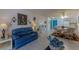 Open-concept living room with dining area, blue accent door and tile flooring at 205 E Harmon Ave # 121, Las Vegas, NV 89169