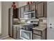 Well-organized kitchen features stainless steel appliances, granite counters and dark wood cabinets at 2096 Fallsburg Way, Henderson, NV 89002