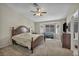 Spacious main bedroom features large window, plush carpet, ceiling fan, and ensuite bathroom at 2096 Fallsburg Way, Henderson, NV 89002