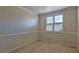 Simple bedroom with neutral carpeting and a bright window at 211 Crown Imperial St, Henderson, NV 89074