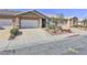 Townhome with private garage and desert landscaping with sidewalk at 211 Crown Imperial St, Henderson, NV 89074