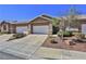 Street view of the townhome showcases its front yard, garage, and overall curb appeal at 211 Crown Imperial St, Henderson, NV 89074