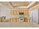 Bright kitchen features white appliances, tiled counters, and a functional layout at 211 Crown Imperial St, Henderson, NV 89074