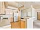 Bright kitchen featuring light wood cabinets, white appliances and tile countertops at 211 Crown Imperial St, Henderson, NV 89074
