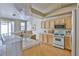 Bright kitchen featuring light wood cabinets, white appliances and tile countertops at 211 Crown Imperial St, Henderson, NV 89074