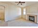 Living room featuring a fireplace, ceiling fan, and neutral colored walls at 211 Crown Imperial St, Henderson, NV 89074