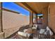 Cozy covered patio with comfortable seating and privacy wall at 211 Crown Imperial St, Henderson, NV 89074