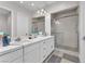 Well-appointed bathroom with double sinks, granite countertops, and a glass-enclosed shower at 2503 Cracked Stone St, Henderson, NV 89044