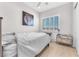 Bright bedroom with a large window, a modern dresser, and a striking lion art piece above the bed at 2503 Cracked Stone St, Henderson, NV 89044