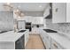 Modern kitchen featuring white cabinetry, stainless steel appliances, and a stylish backsplash at 2503 Cracked Stone St, Henderson, NV 89044