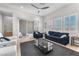 Spacious living room featuring contemporary furniture, a ceiling fan, and access to an outdoor patio at 2503 Cracked Stone St, Henderson, NV 89044