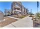 Modern townhomes featuring concrete sidewalks, tiered landscaping and a peek at neighborhood amenities at 2503 Cracked Stone St, Henderson, NV 89044