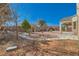 Landscaped backyard featuring a covered patio and drought resistant features at 2617 Tanagrine Dr, North Las Vegas, NV 89084