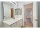 Bathroom with a wide mirror, vanity with white cabinets, and tiled flooring at 2617 Tanagrine Dr, North Las Vegas, NV 89084