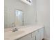 Bright bathroom featuring a large mirror, white cabinets, and a view into the tiled shower at 2617 Tanagrine Dr, North Las Vegas, NV 89084