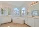 Bright bathroom with dual sinks, soaking tub, and large mirrors at 2617 Tanagrine Dr, North Las Vegas, NV 89084