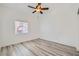 Cozy bedroom with ceiling fan, wood-look flooring, and natural light at 2617 Tanagrine Dr, North Las Vegas, NV 89084