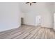 Large bedroom with wood-look floors, neutral walls, and arched doorways at 2617 Tanagrine Dr, North Las Vegas, NV 89084