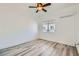 Bright bedroom features a window and a ceiling fan with wood-look flooring at 2617 Tanagrine Dr, North Las Vegas, NV 89084